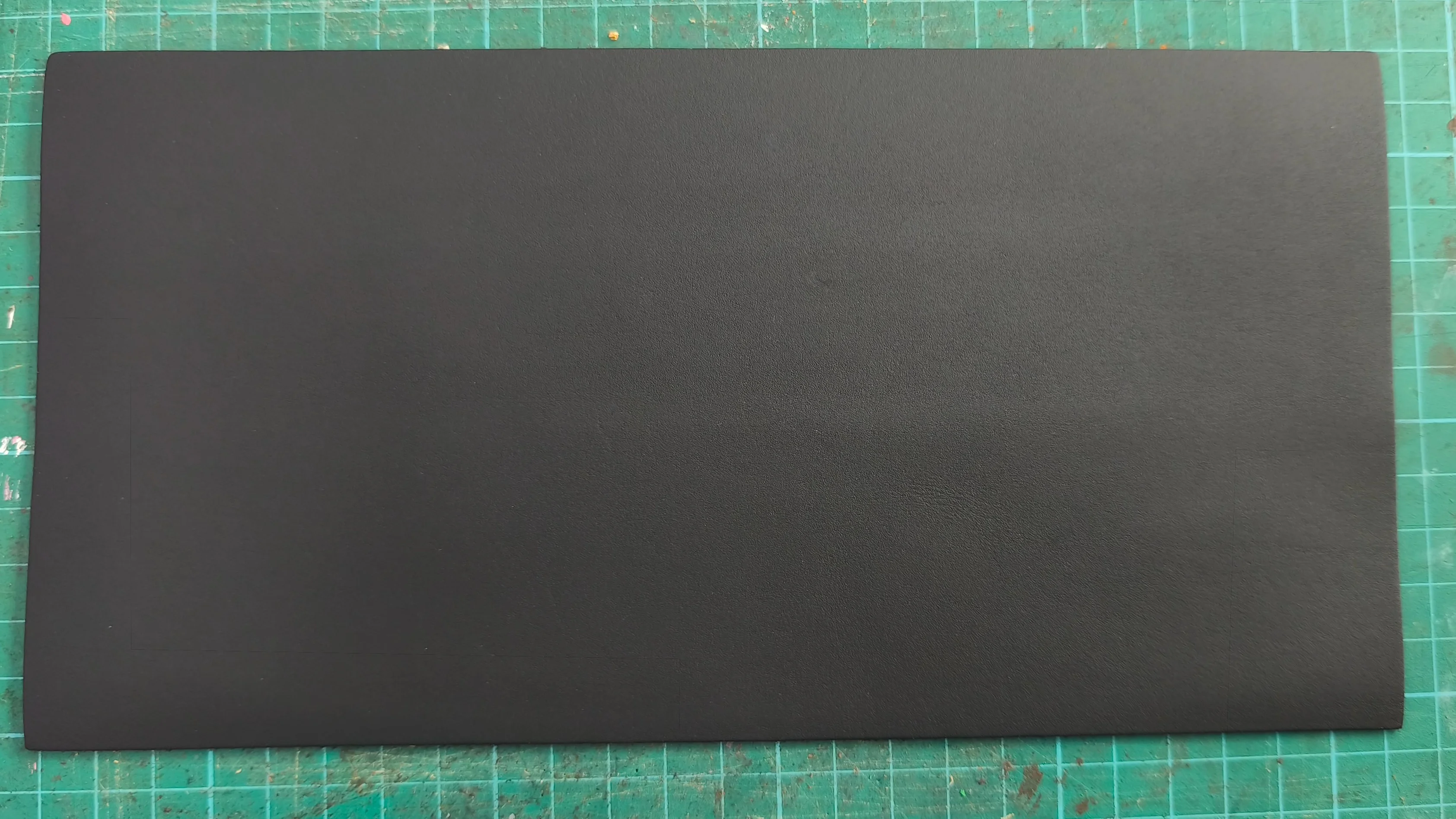 Artisan inspecting vegetable-tanned leather fiber structure